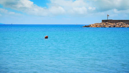 red buoy in Fertilia harbor on a cloudy dayの写真素材
