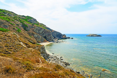 rocky shore under a cloudy sky in Sardinia, Italyの写真素材
