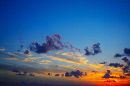 colorful sunset with dark cloudsの写真素材