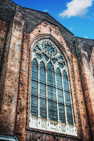 huge window in San Petronio cathedral side wall in Bologna, Italyの写真素材