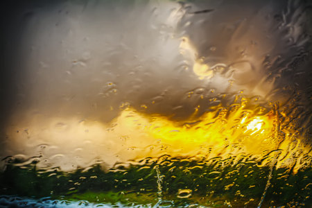 wet windshield on a rainy day at sunsetの写真素材