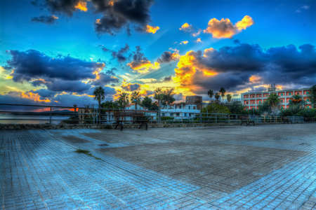 bench in a square by the sea in Fertilia, Italyの写真素材
