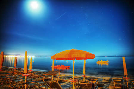 umbrella under a starry sky in Alghero, Italyの写真素材