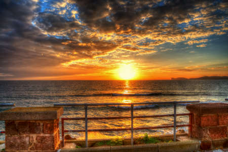 colorful sunset in Alghero seafront, Italyの写真素材