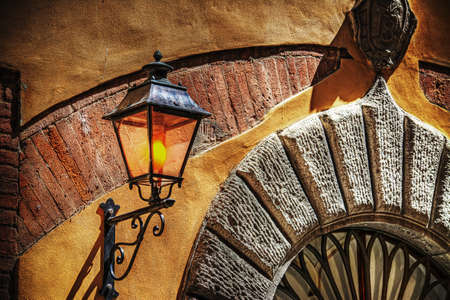 close up of a rustic light in a typical Italian entranceの写真素材