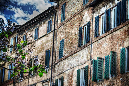 old building under a cloudy sky in Siena, Italyの写真素材