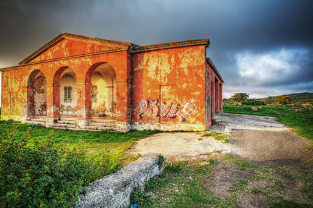 old orange house under a dramatic skyの写真素材