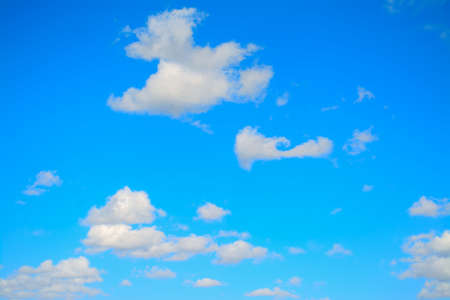 blue sky with white, soft cloudsの写真素材