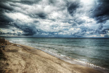 dramatic sky over the sea in the winterの写真素材