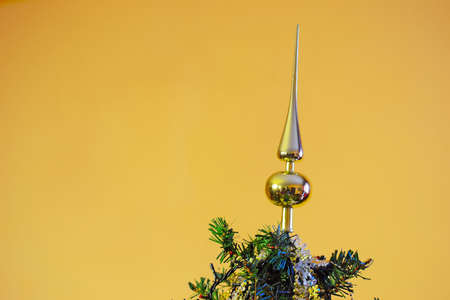 Christmas tree topper on a golden backgroundの写真素材