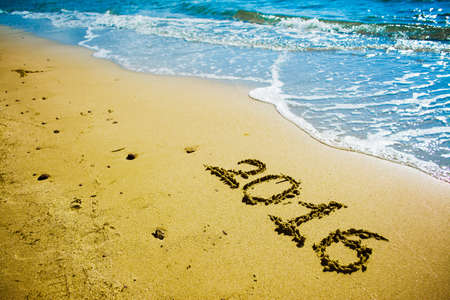 2016 written on a golden shoreの写真素材
