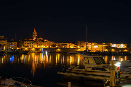 alghero cityscape seen from the harbor at night, Italyの写真素材