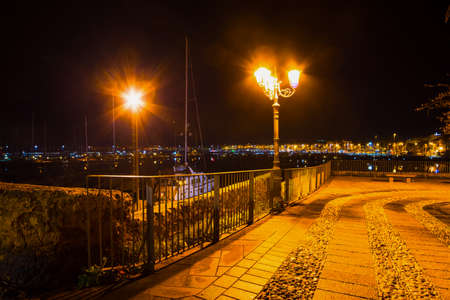 metal fence in Alghero shoreline at night, Italyの写真素材
