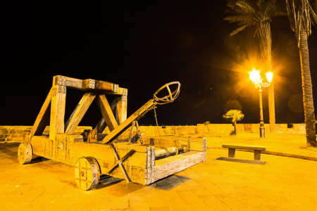 antique catapult in Alghero at night, Italyの写真素材