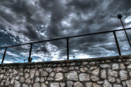 stone wall under a dramatic  grey sky in Sardinia, Italyの写真素材