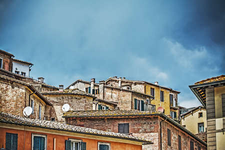 antique roofs in Siena, Italyの写真素材