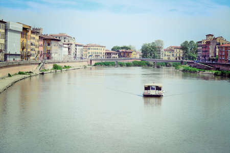 boat in Arno river, Pisaの写真素材