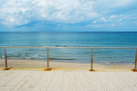 metal railing by the shore in Sardinia, Italyの写真素材