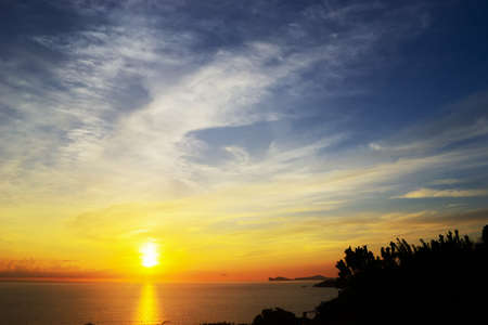 shining sun over the horizon at sunsetの写真素材