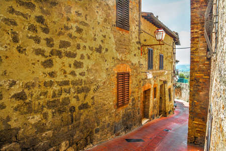 brick facade in a narrow street in San Gimignano, Italyの写真素材
