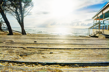 wooden boardwalk by the shore in Sardinia, Italyの写真素材