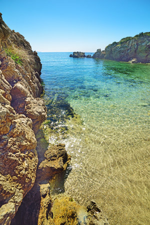 rocky shore and crystal clear water in Sardinia, Italyの写真素材