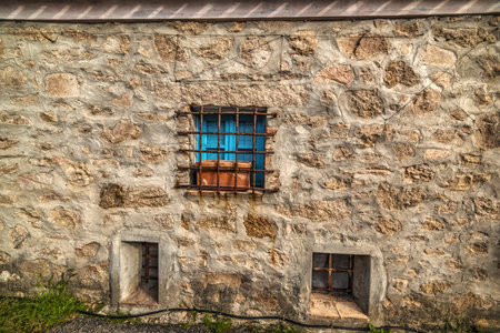 blue window in a rustic wall in Sardinia, Italy