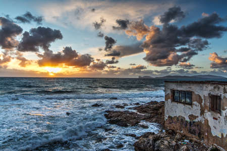 dramatic sky over a ruin at sunsetの写真素材