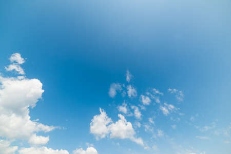 blue sky with white, soft cloudsの写真素材