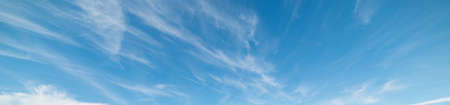 blue sky with white, soft cloudsの写真素材