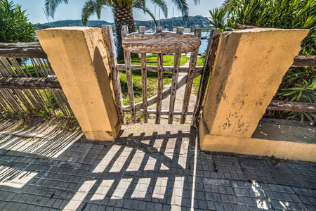 small wooden gate in Cannigione harbor, Italy