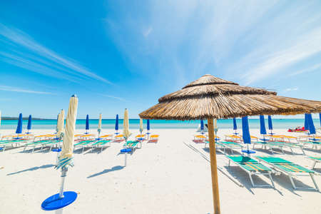 straw parasol with closed umbrellas in the backgroundの写真素材