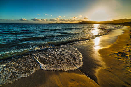 shining sun over Alghero shoreline at sunset, Sardiniaの写真素材