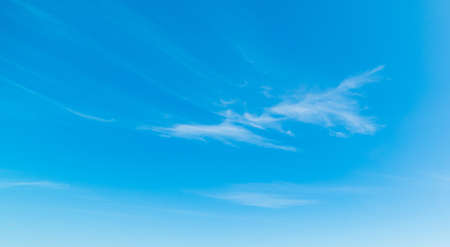 blue sky with white, soft cloudsの写真素材