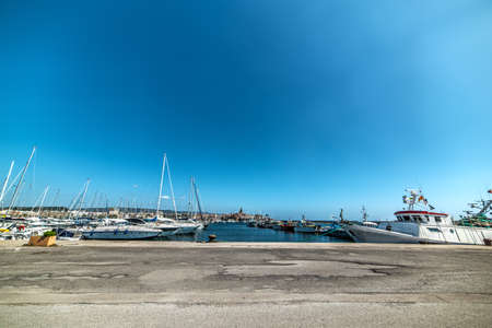 Alghero harbor under a shining sun, Italyの写真素材