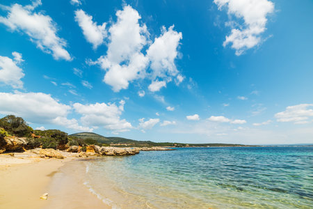 cloudy sky over a small cove in Alghero, Sardiniaの写真素材