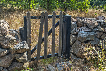 small wooden gate in a dry stone wall
