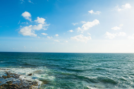 turquoise sea under a blue sky with cloudsの写真素材