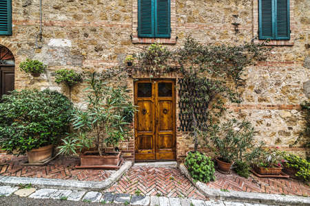 wooden door in a rustic wall in Montecatini, Italyの写真素材