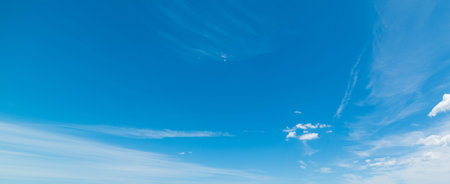 blue sky with white, soft cloudsの写真素材