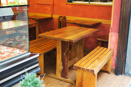 wooden tables and benches in an Italian Pizzeriaの写真素材