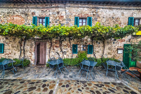 tables and chairs in Monteriggioni, Italyの写真素材