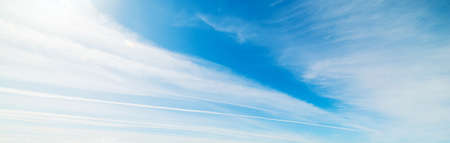 blue sky with white, soft cloudsの写真素材