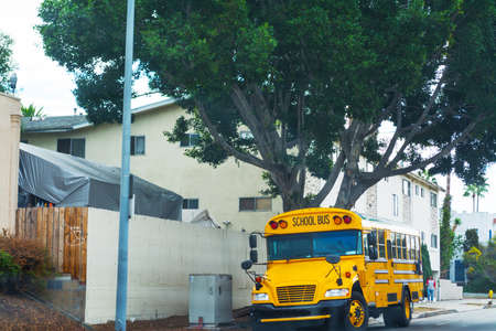 School bus on the edge of the road in Los Angeles, Californiaの写真素材