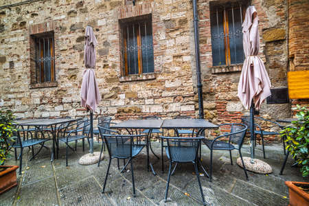 wrought-iron tables and chairs by a trattoria in Tuscany, Italyの写真素材