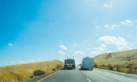 Truck overtaking a caravan in Interstate 5, Californiaの写真素材