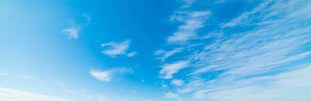 blue sky with white, soft cloudsの写真素材