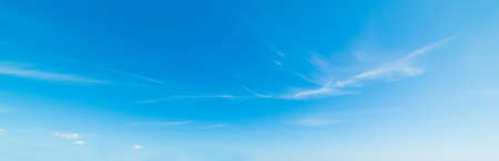 blue sky with white, soft cloudsの写真素材