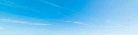 blue sky with white, soft cloudsの写真素材