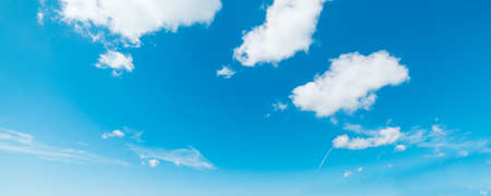 blue sky with white, soft cloudsの写真素材